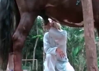 Elegant blonde masturbates a horse dick