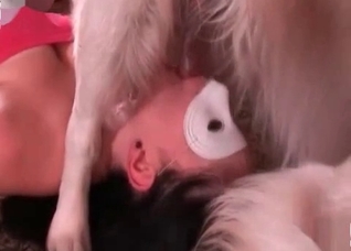 Masked whore sucks a doggy