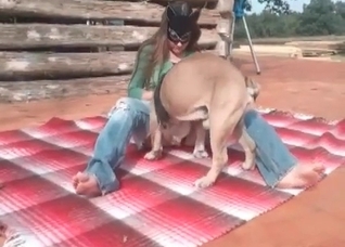 Masked lass and her playful dog
