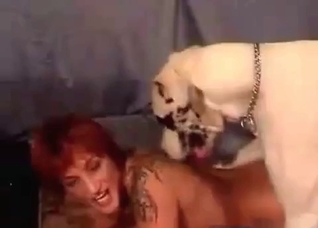Tanned redhead fucks with a dog