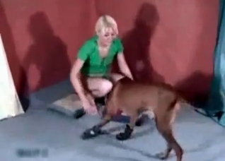 Blondie in green fucks a mean dog